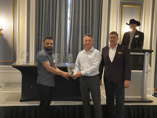 NurtriScan Awarded first place in Agronomics at Ag In Motion Innovations Showcase .Photographed from left to right: Simranjit Singh (Project lead, ATP), Vince Puchailo (District VP, TD Agricultural Services), and Scott Moe (Premier of Saskatchewan)